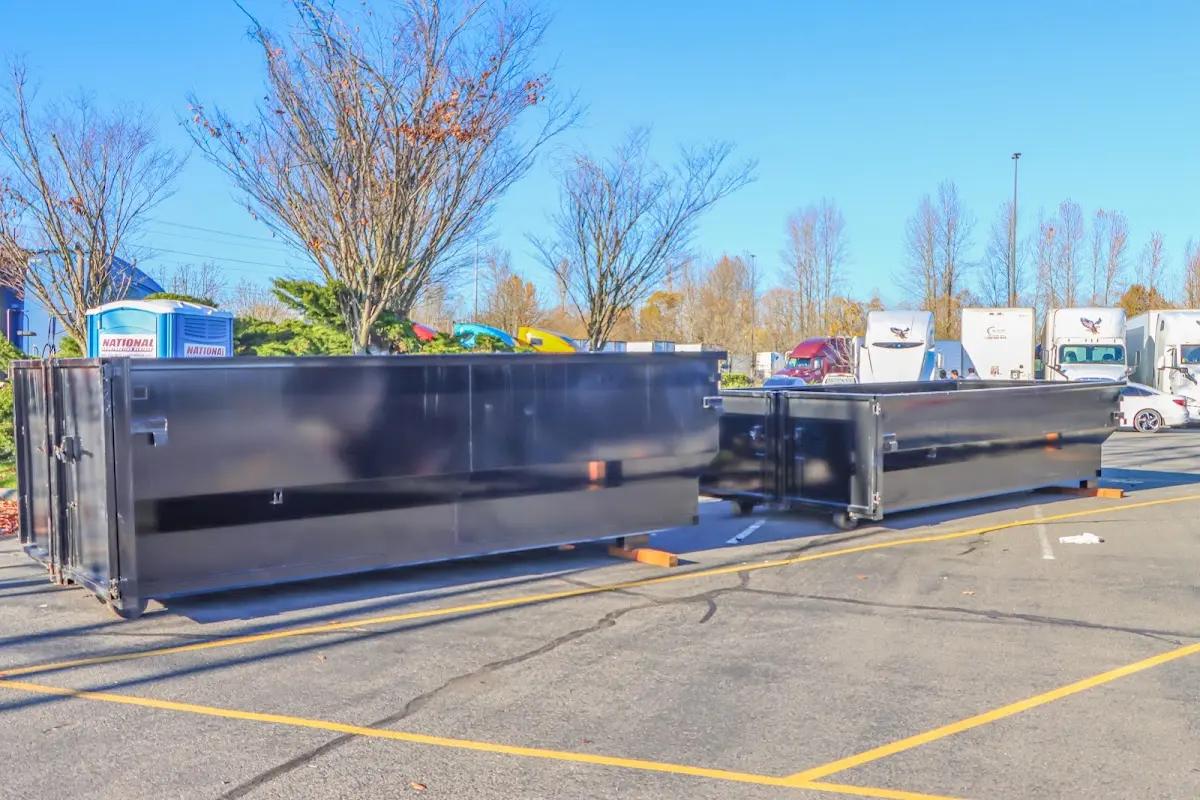 Professional dumpster rental service with roll-off container on residential driveway in Blaine